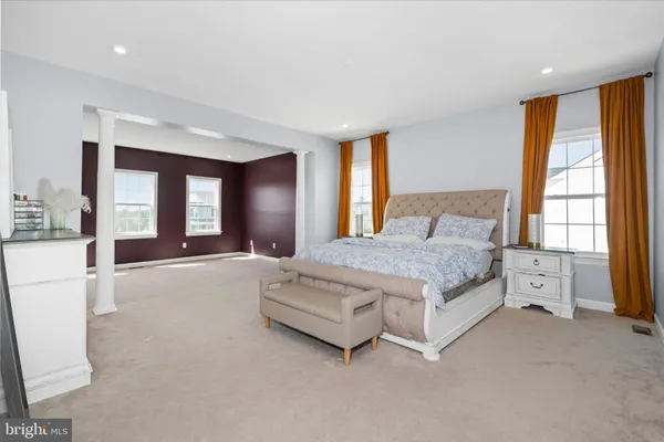 a spacious bedroom with a large bed and a large window