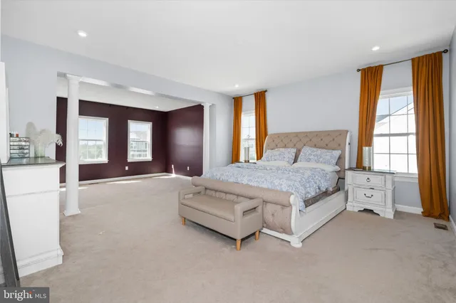 a spacious bedroom with a large bed and a large window