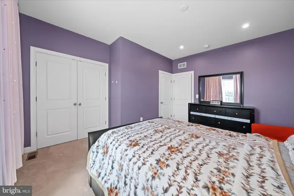 a bedroom with a bed and a television