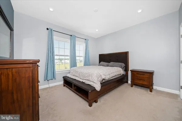 a bedroom with a bed lamp closet and window