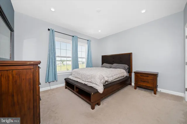 a bedroom with a bed lamp closet and window