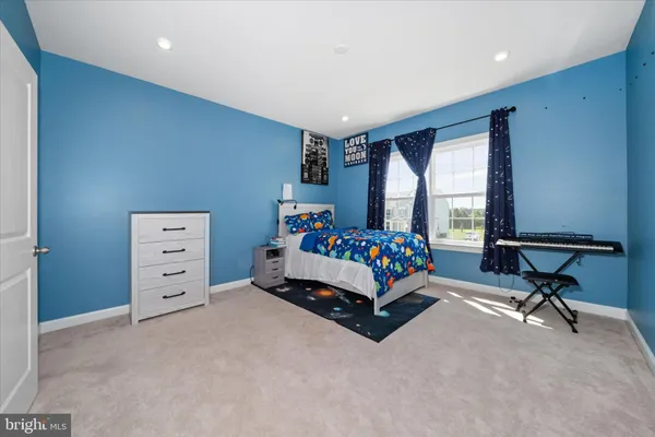 a bedroom with furniture and a large window