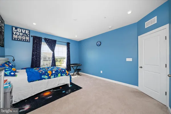 a living room with furniture and flowers