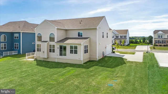 a view of a house with a yard and sitting area