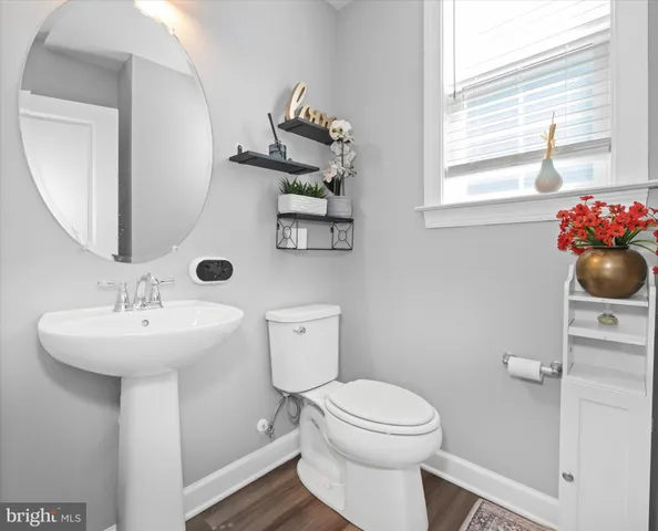 a bathroom with a sink mirror and toilet