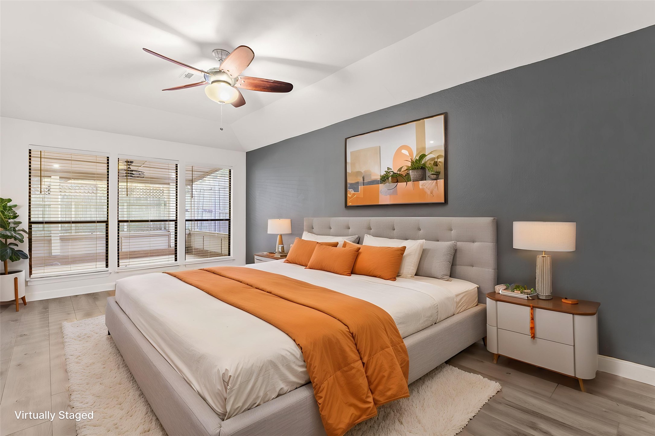 2409 Water Well Lane Austin, TX 78728 - Photo 11 of 22 Bedroom featuring an accent wall, vaulted ceiling, and three large windows