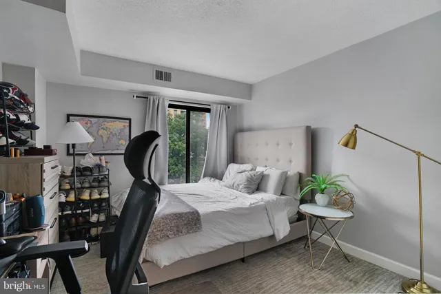 a bedroom with bed and a table