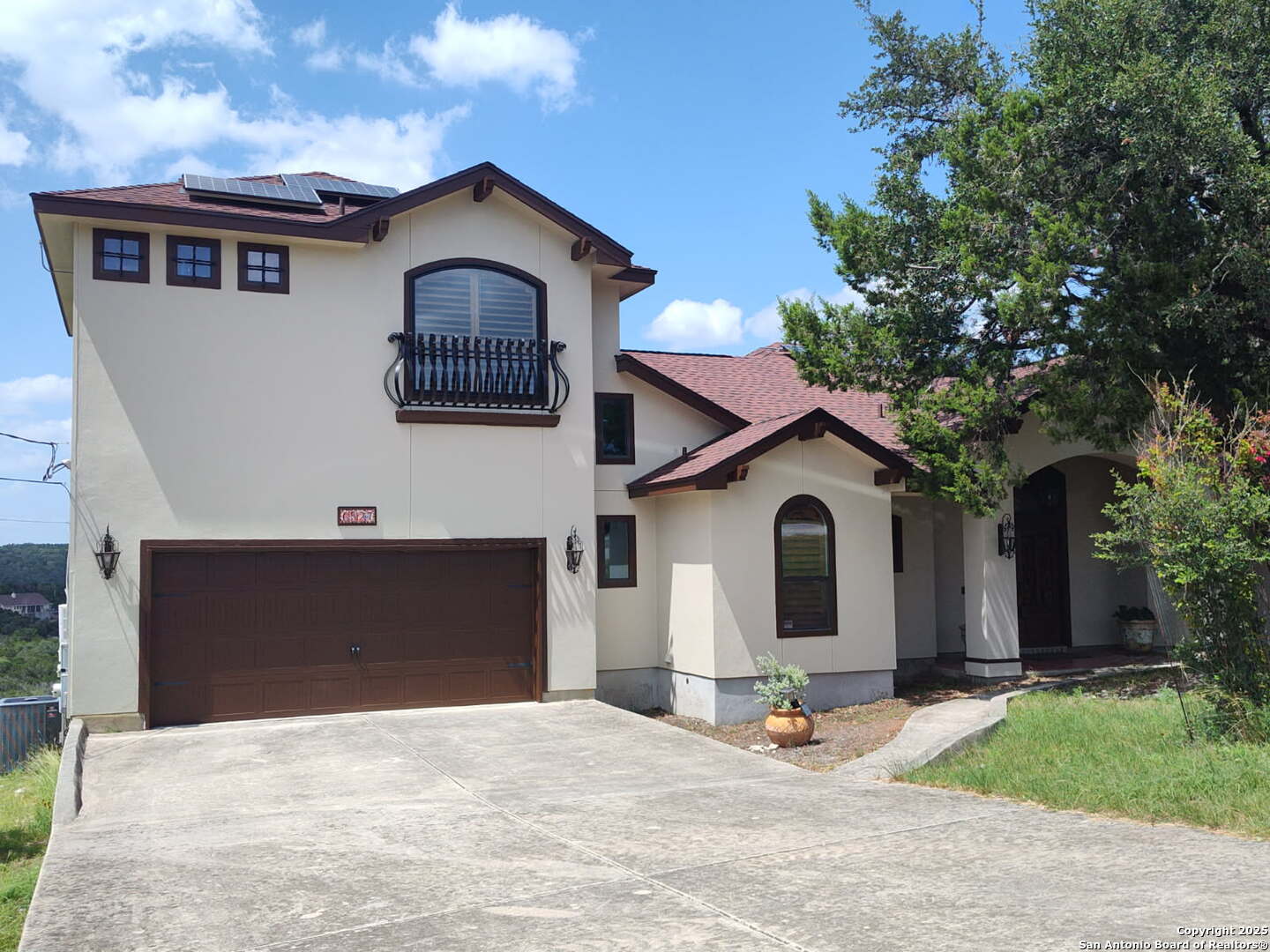 a front view of a house with garage and yard
