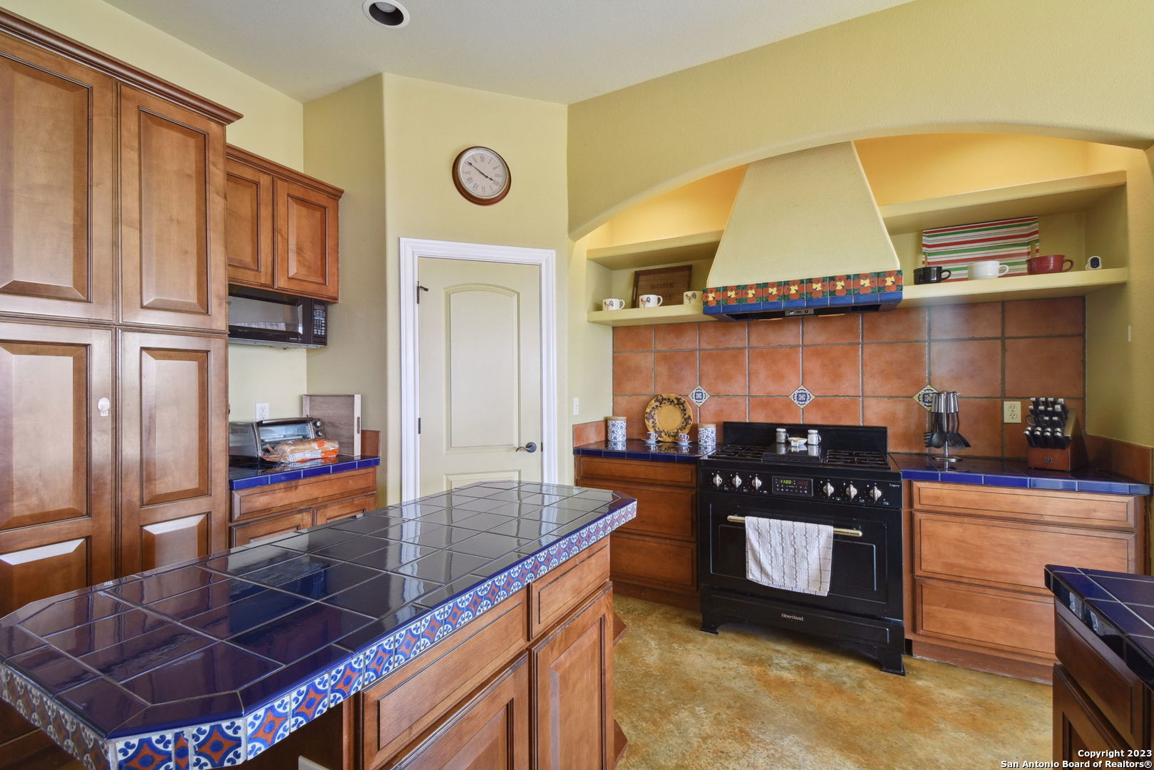 6527 Preakness Pass Bulverde, TX 78163 - Photo 12 of 22 a kitchen with stainless steel appliances granite countertop a stove a sink and a refrigerator