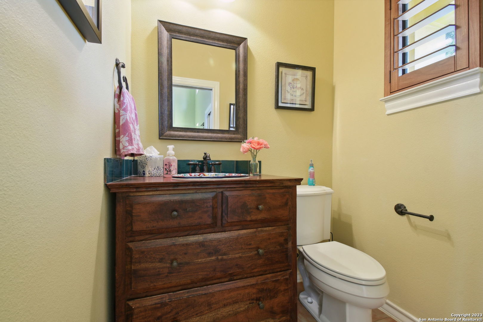 6527 Preakness Pass Bulverde, TX 78163 - Photo 14 of 22 a bathroom with a toilet sink vanity and mirror