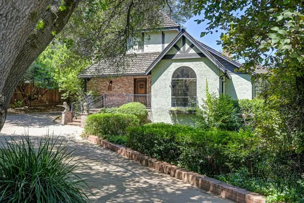 a front view of a house with a garden