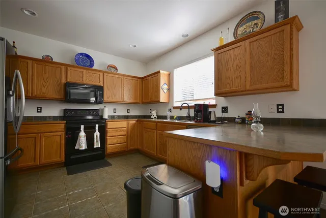 a kitchen with stainless steel appliances granite countertop a sink and a stove