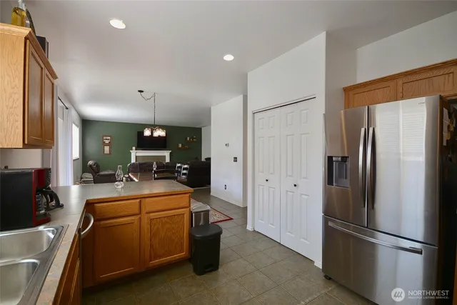 a kitchen with a refrigerator a stove top oven and a sink