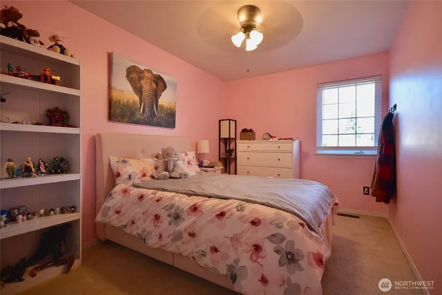 a bedroom with a bed and dresser with shelf