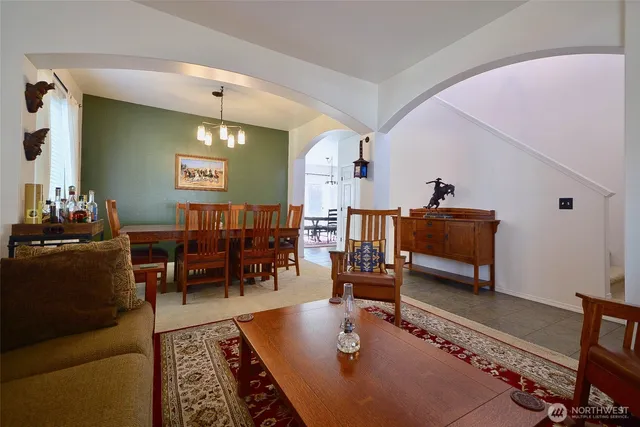 a living room with furniture a rug and a flat screen tv