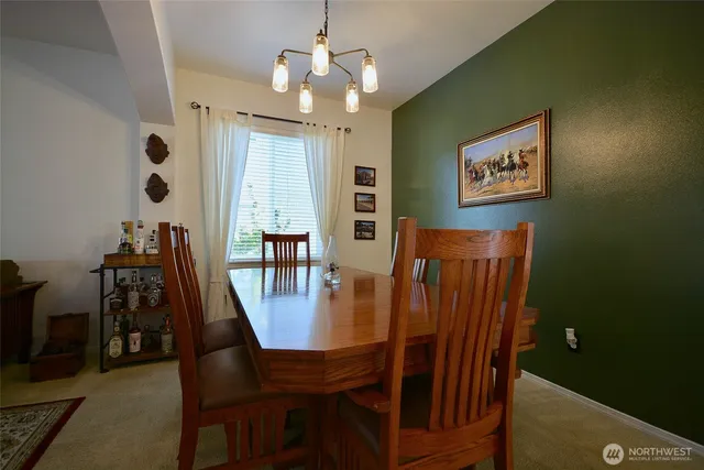 a view of a dining room with furniture and chandelier