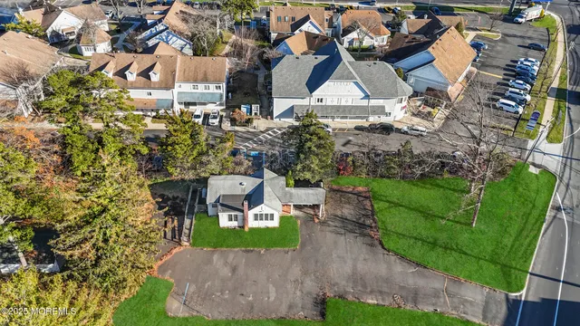an aerial view of a house with garden space and street view