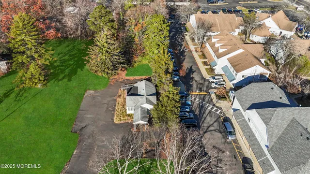 an aerial view of a house with a yard basket ball court