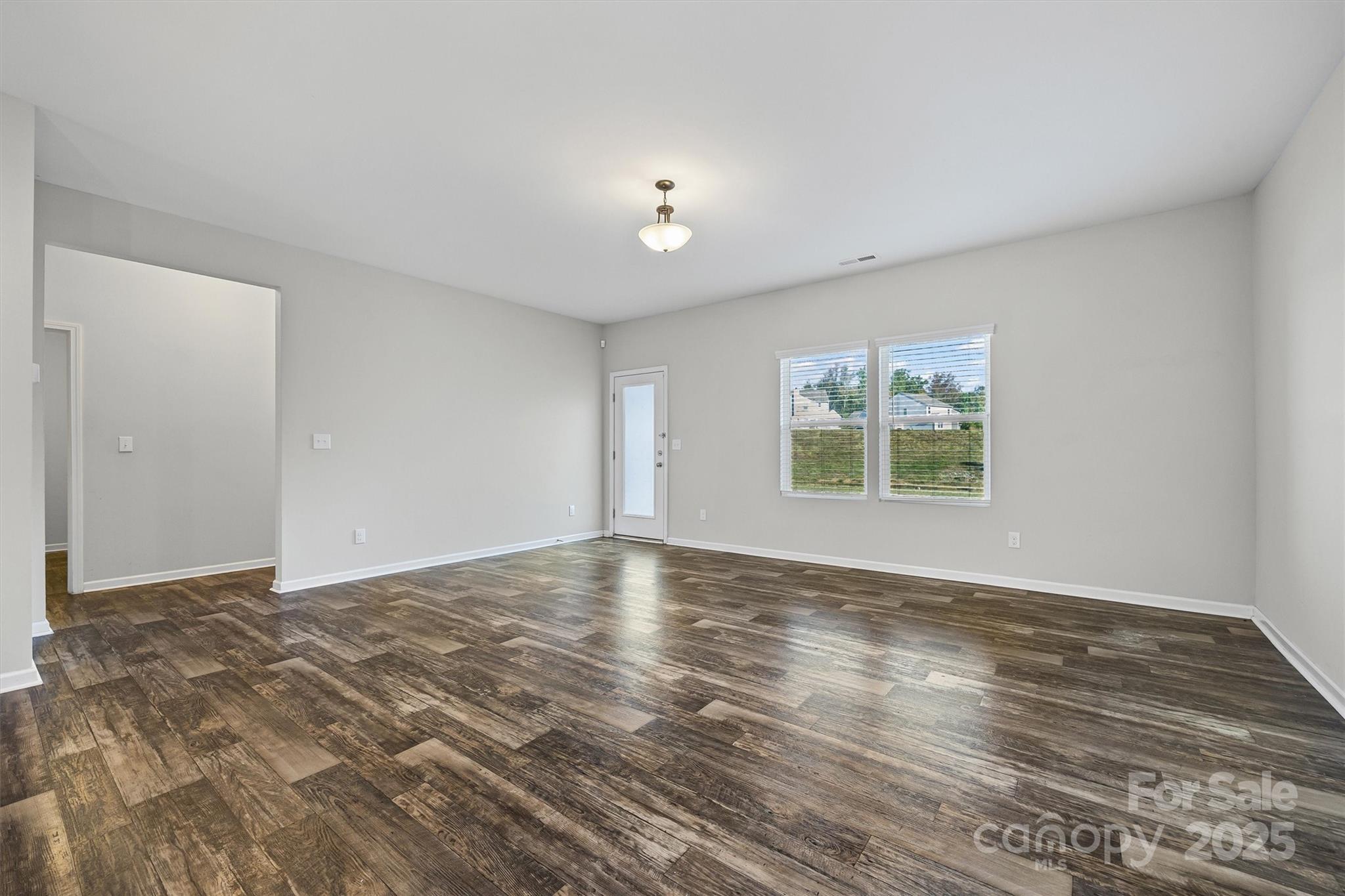 730 Gants Road York, SC 29745 - Photo 11 of 37 a view of an empty room with wooden floor and a window