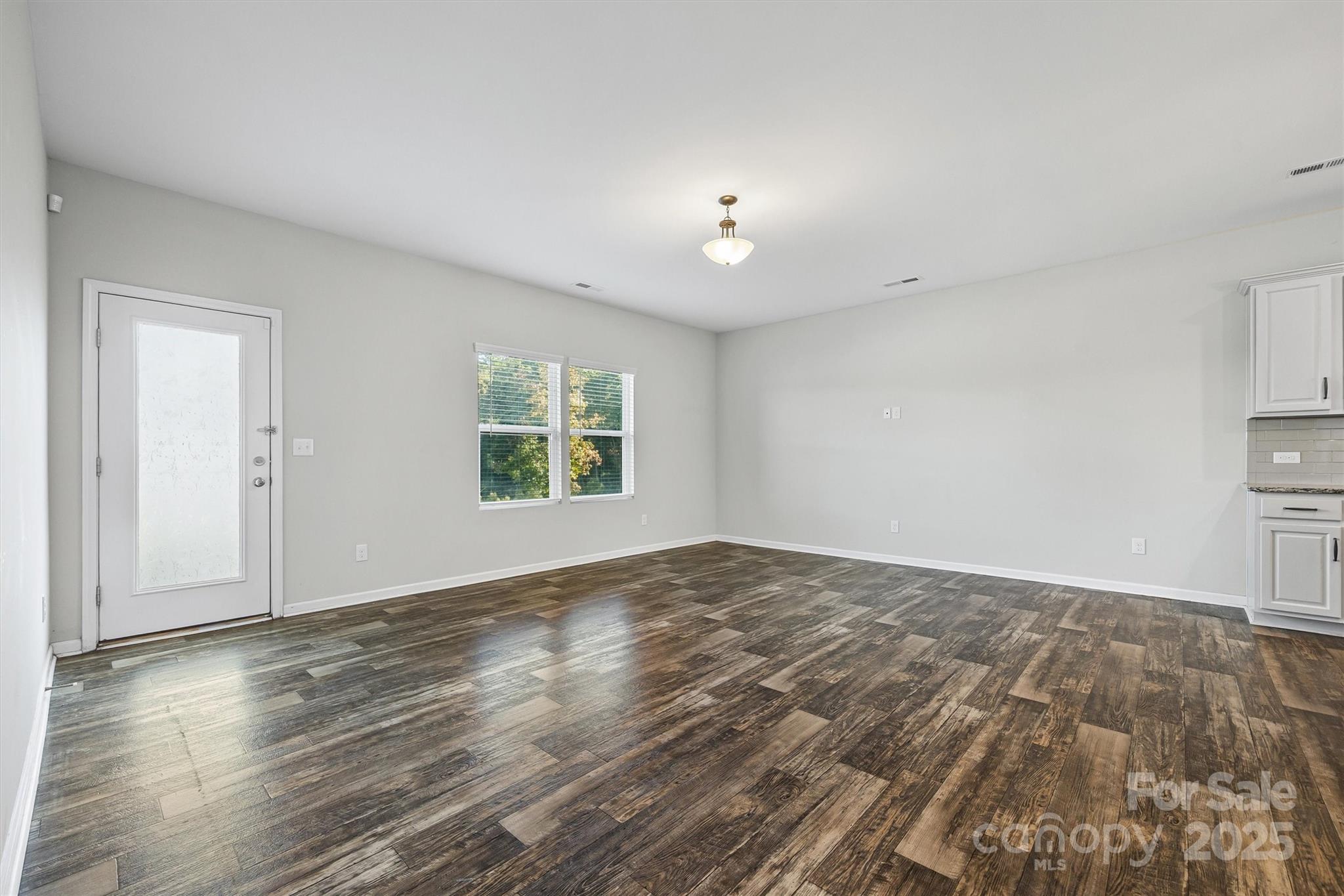 730 Gants Road York, SC 29745 - Photo 13 of 37 an empty room with wooden floor and windows