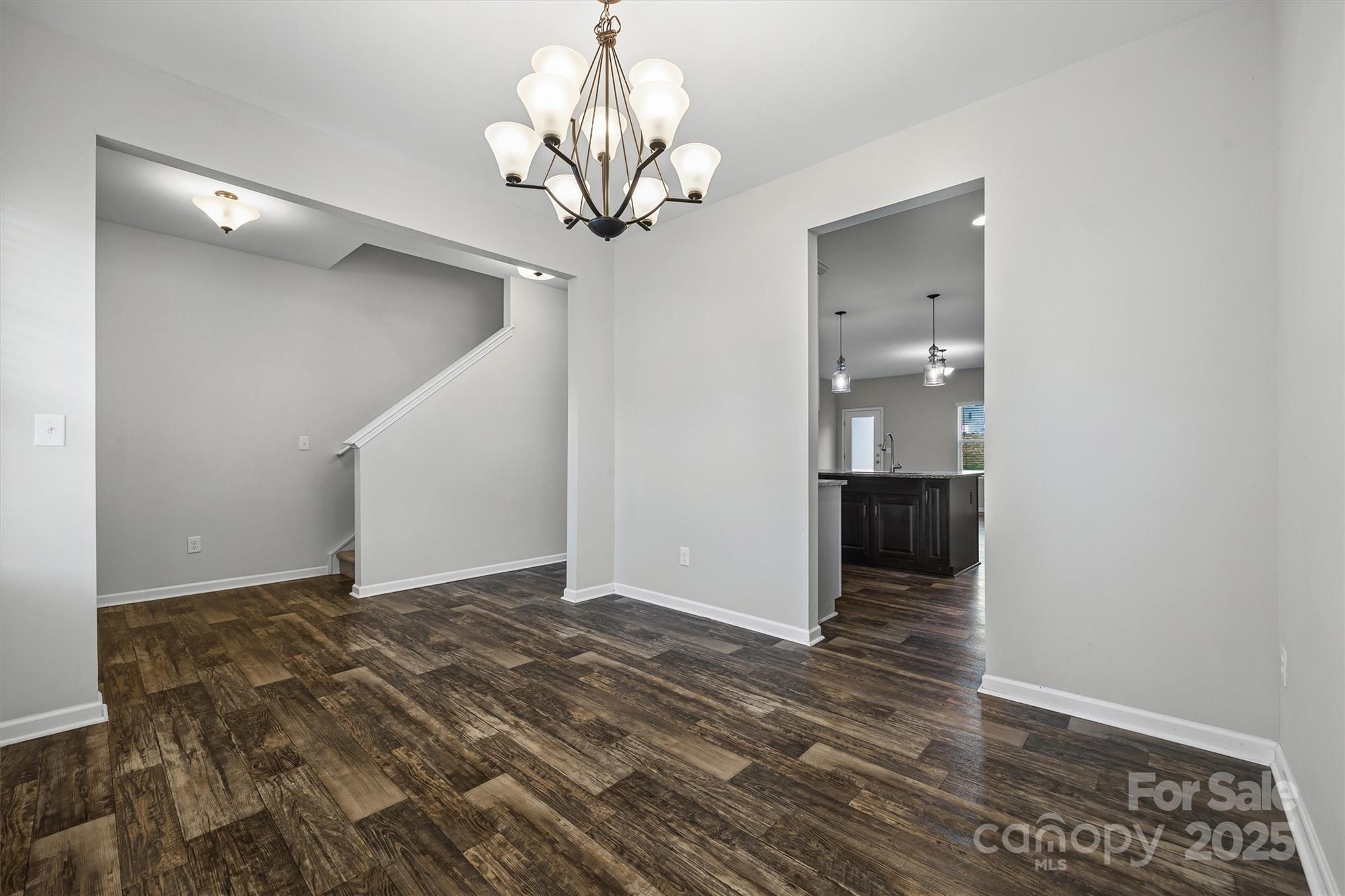 730 Gants Road York, SC 29745 - Photo 6 of 37 a view of a hallway with wooden floor and a chandelier
