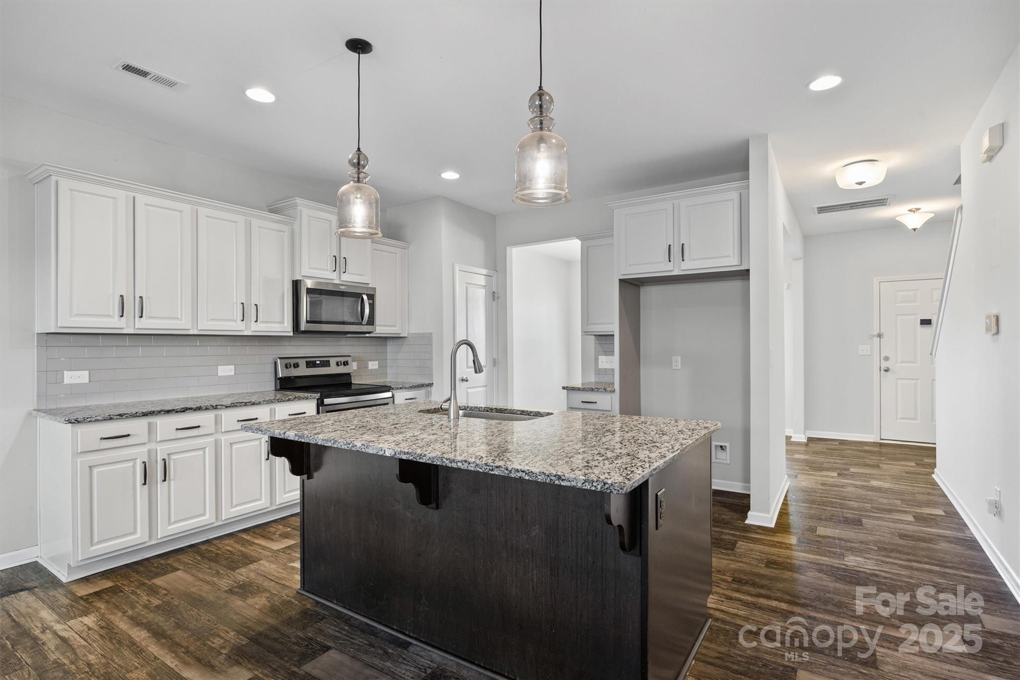730 Gants Road York, SC 29745 - Photo 8 of 37 a kitchen with kitchen island granite countertop a sink a center island a stove and a cabinets