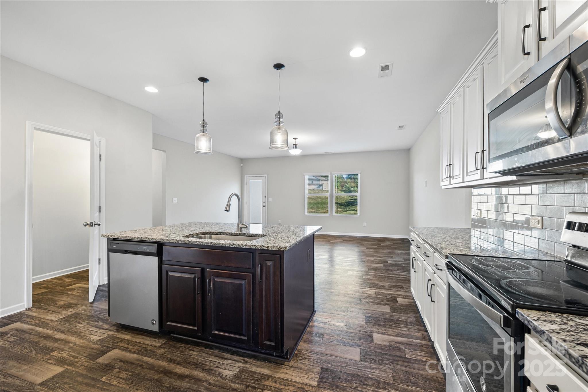 730 Gants Road York, SC 29745 - Photo 10 of 37 a kitchen with stainless steel appliances granite countertop a sink a stove and a wooden floors