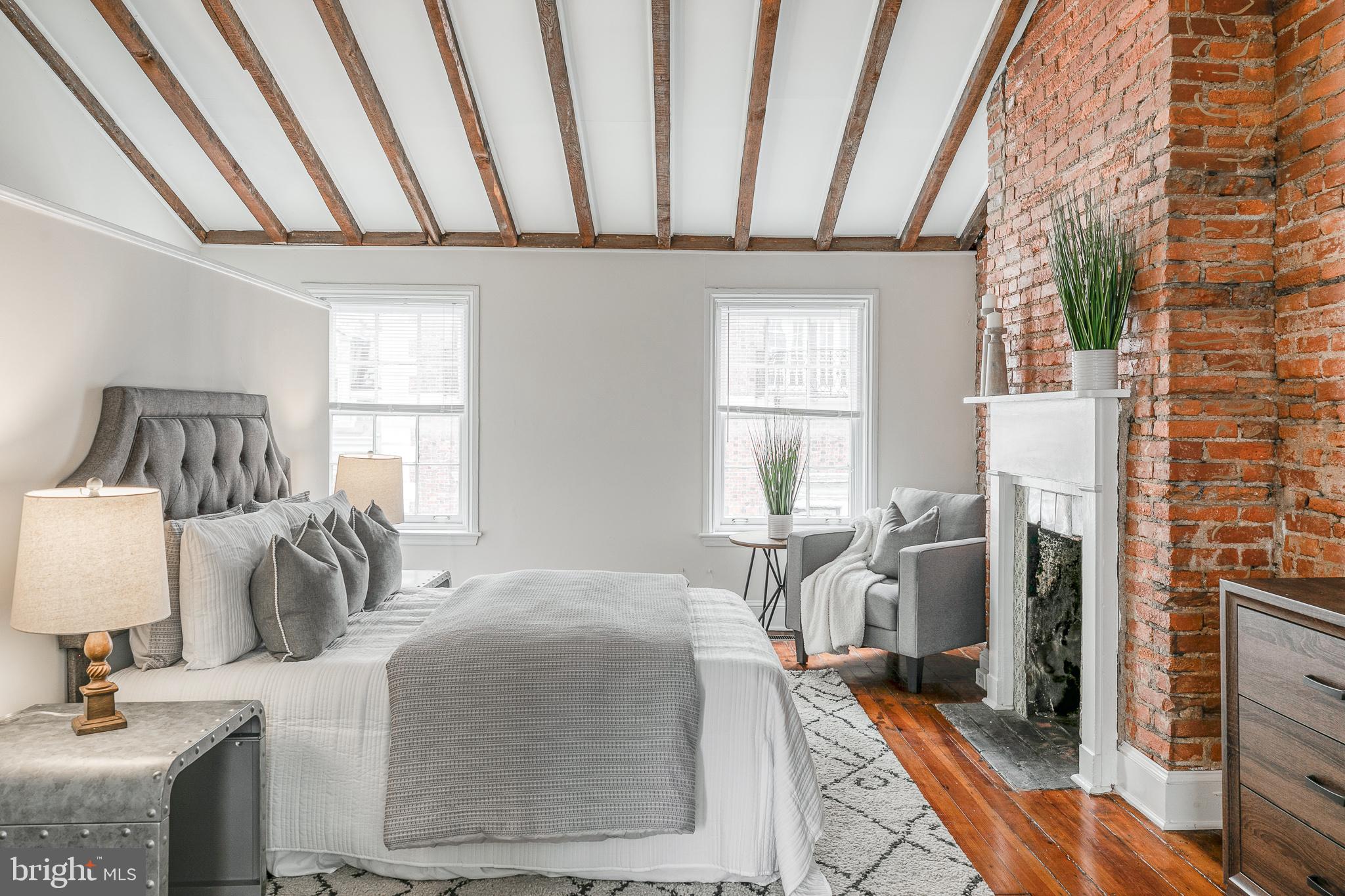 1714 Rittenhouse Square Philadelphia, PA 19103 - Photo 13 of 21 a bedroom with a bed and a table