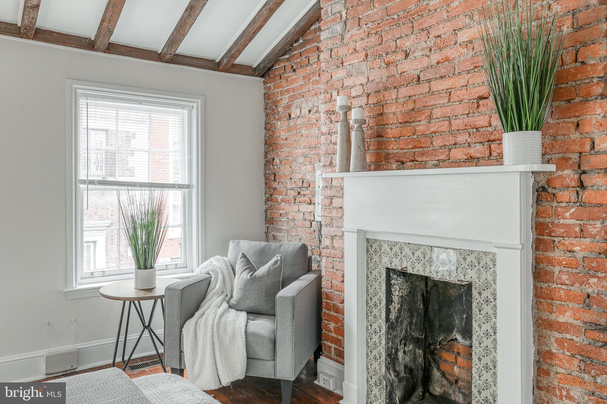 1714 Rittenhouse Square Philadelphia, PA 19103 - Photo 14 of 21 a living room with furniture and a fireplace