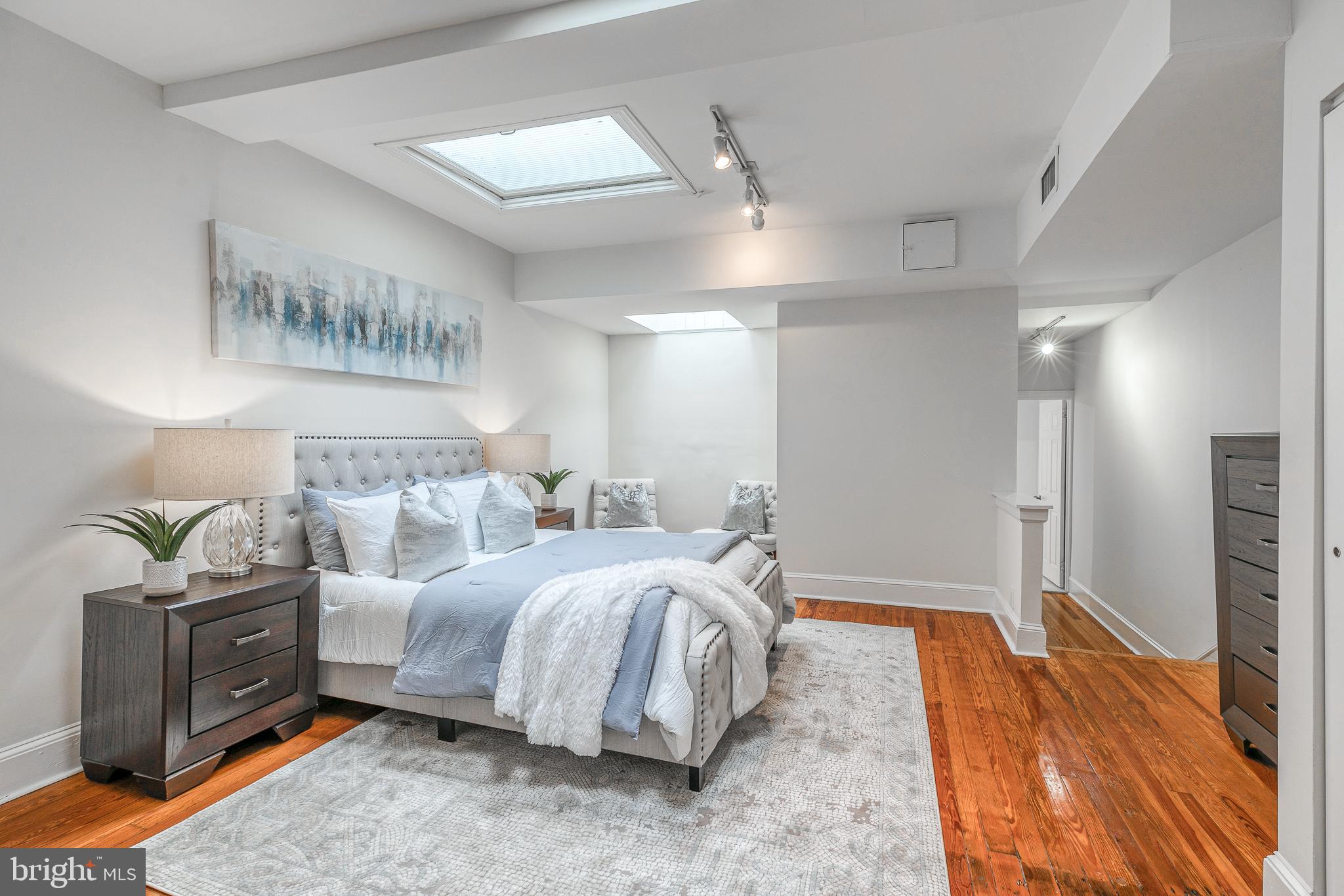 1714 Rittenhouse Square Philadelphia, PA 19103 - Photo 8 of 21 a spacious bedroom with a bed and a chandelier