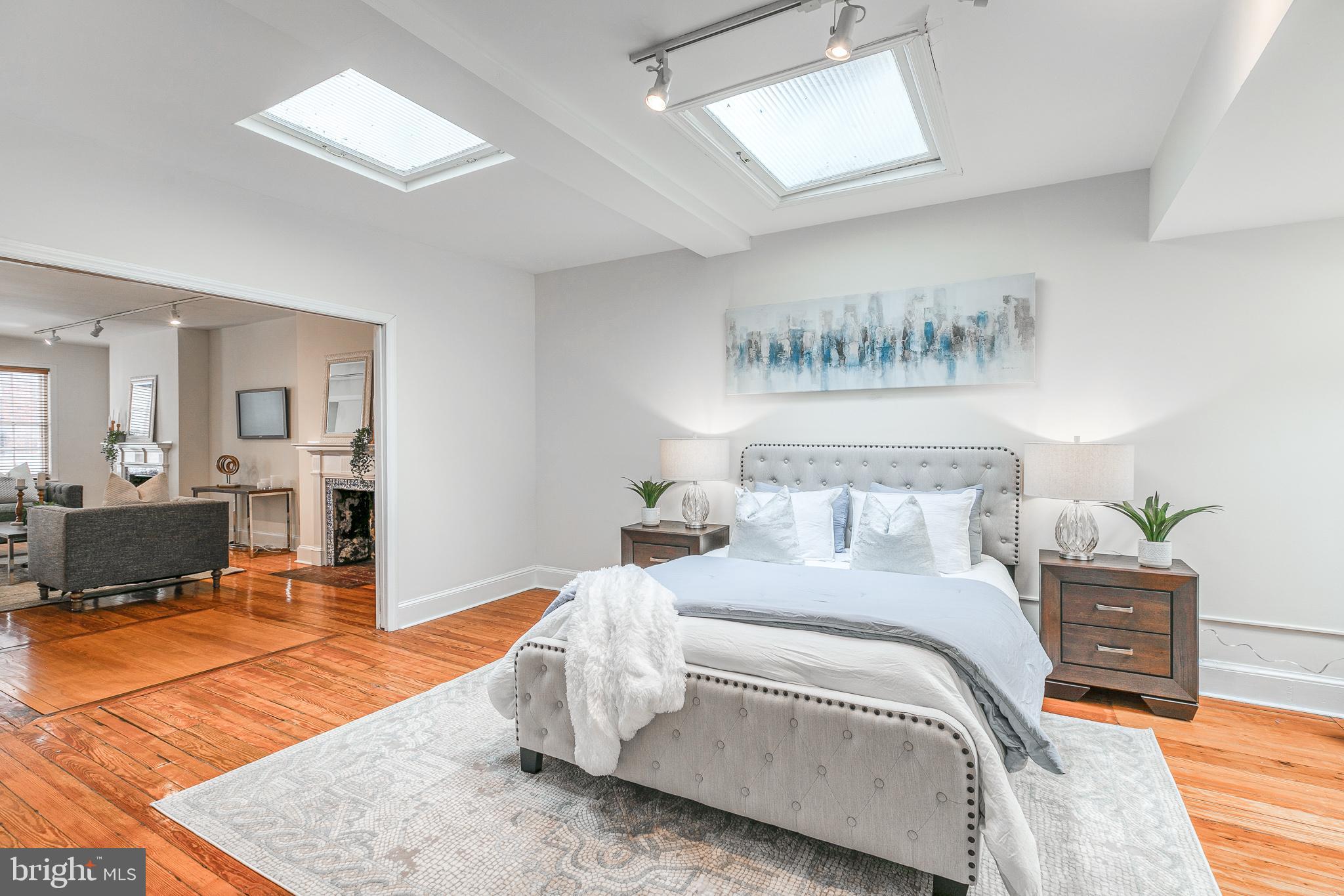1714 Rittenhouse Square Philadelphia, PA 19103 - Photo 9 of 21 a bedroom with a bed a mirror and lamp on desk