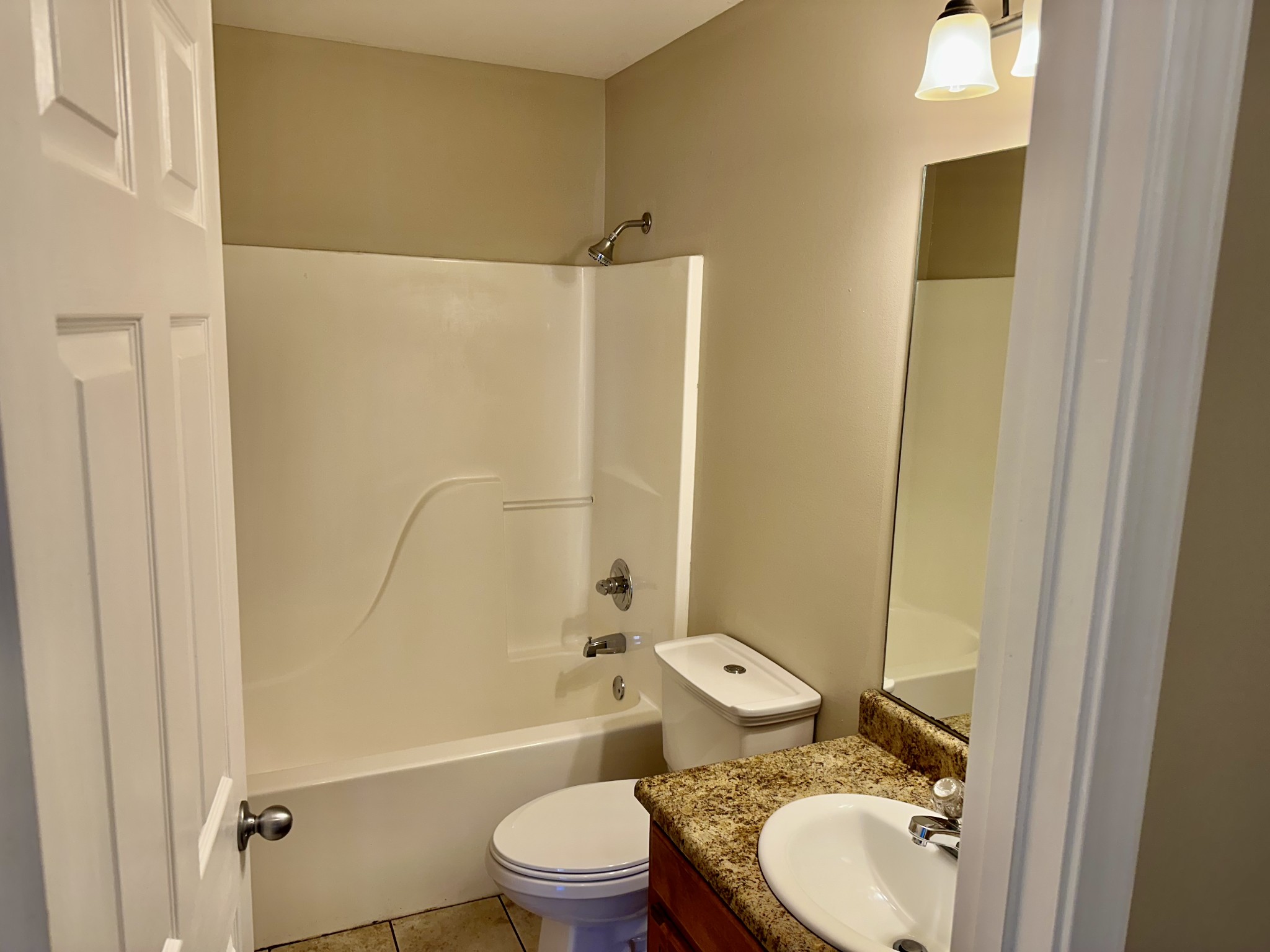 265 Sagewood Drive Pulaski, TN 38478 - Photo 14 of 16 a bathroom with a granite countertop toilet sink and shower