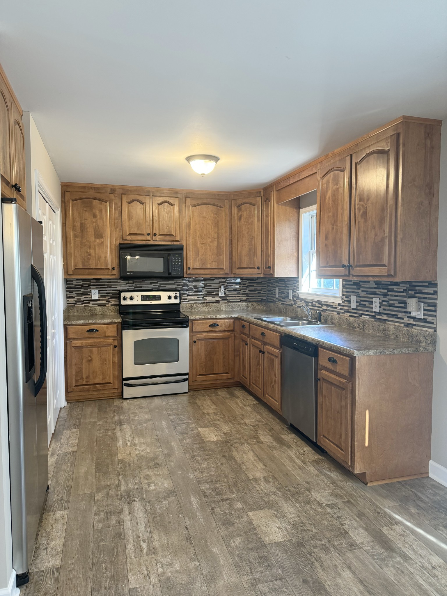 265 Sagewood Drive Pulaski, TN 38478 - Photo 7 of 16 a kitchen with stainless steel appliances granite countertop a stove sink and refrigerator