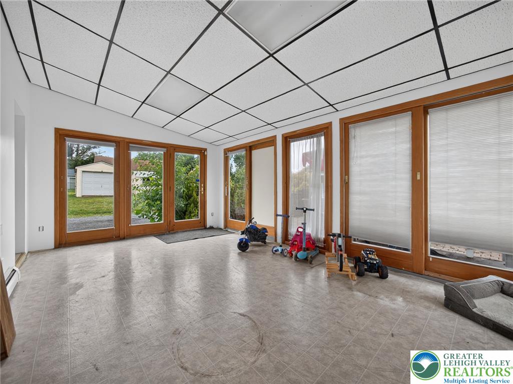 2628 Levans Road Coplay, PA 18037 - Photo 23 of 54 A spacious sunroom offers direct access to the outdoors, ideal for leisure.