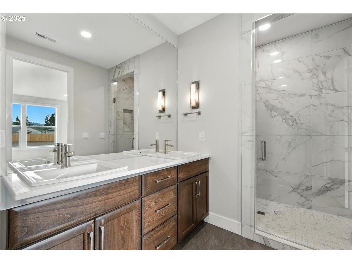 121 Gassman Road Castle Rock, WA 98611 - Photo 14 of 29 a bathroom with a sink double vanity and a mirror