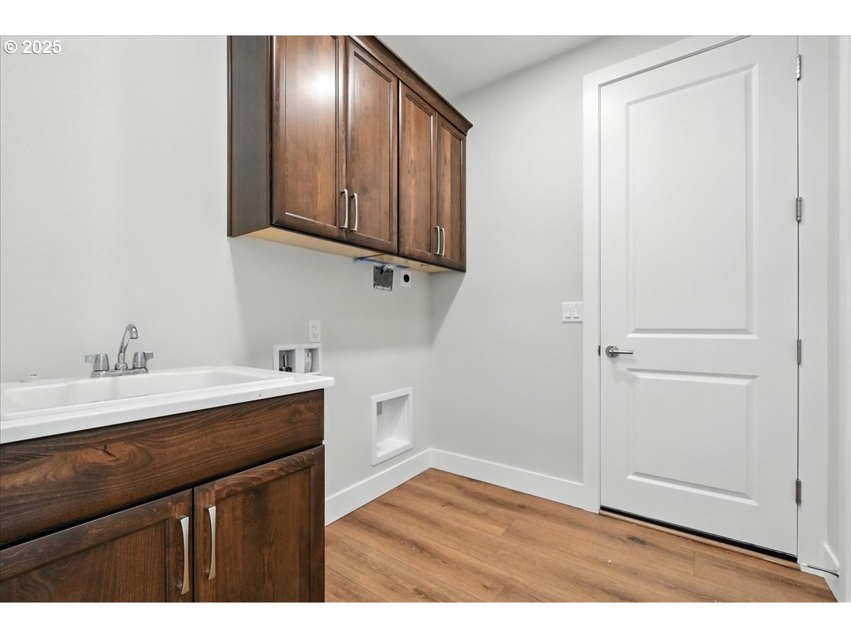 121 Gassman Road Castle Rock, WA 98611 - Photo 20 of 29 a kitchen with cabinets and wooden floor