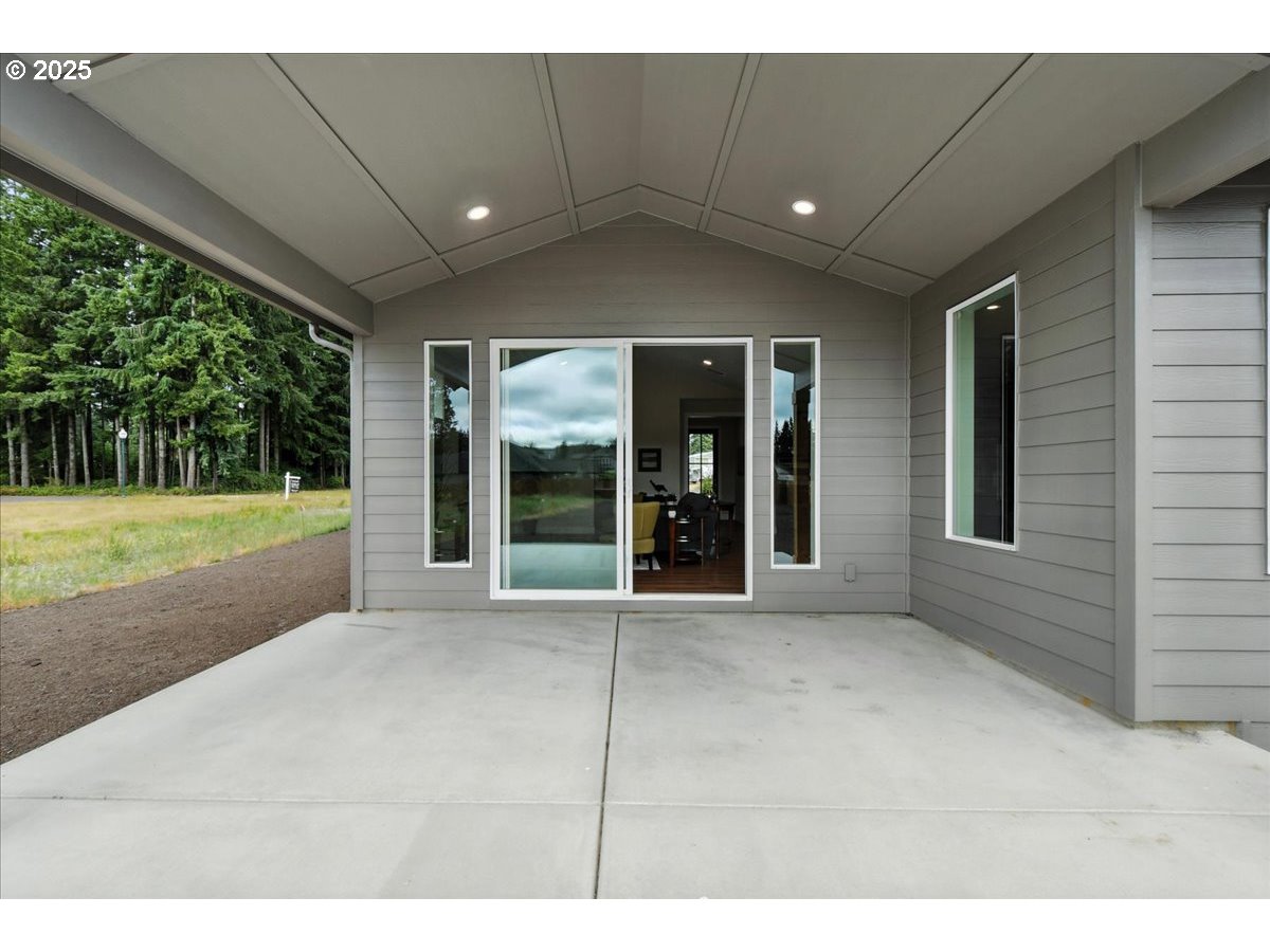 121 Gassman Road Castle Rock, WA 98611 - Photo 22 of 29 a view of a house with a backyard and porch