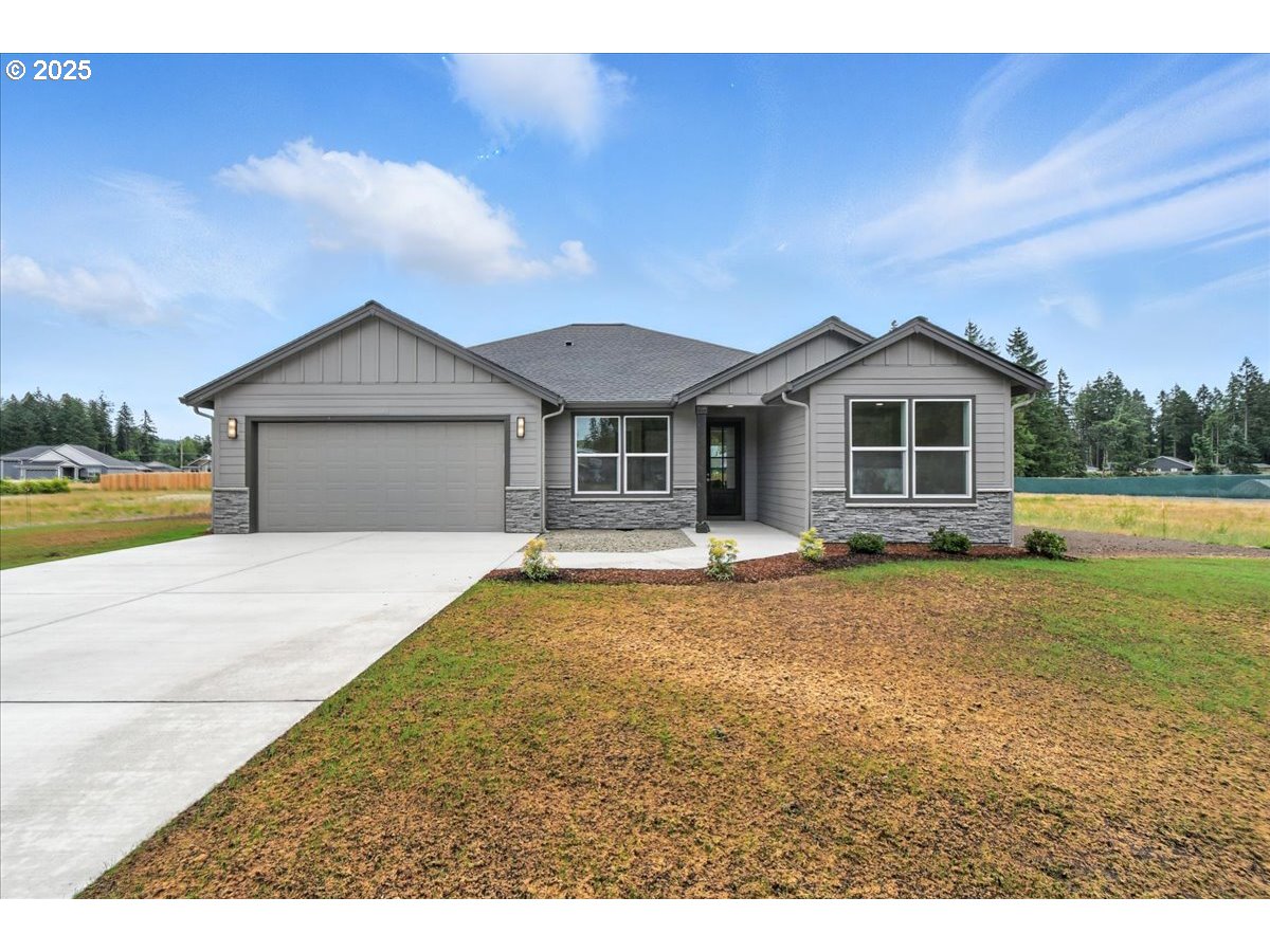 121 Gassman Road Castle Rock, WA 98611 - Photo 26 of 29 a front view of a house with a garden and yard