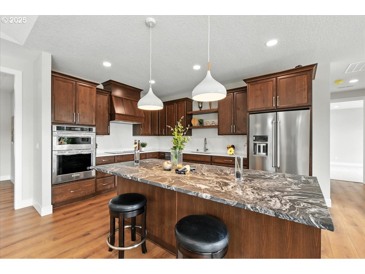 121 Gassman Road Castle Rock, WA 98611 - Photo 10 of 29 a kitchen with stainless steel appliances granite countertop a sink refrigerator and cabinets