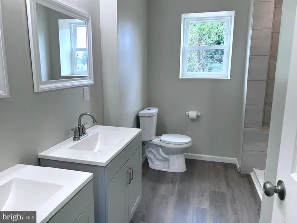 a bathroom with a toilet a sink and mirror