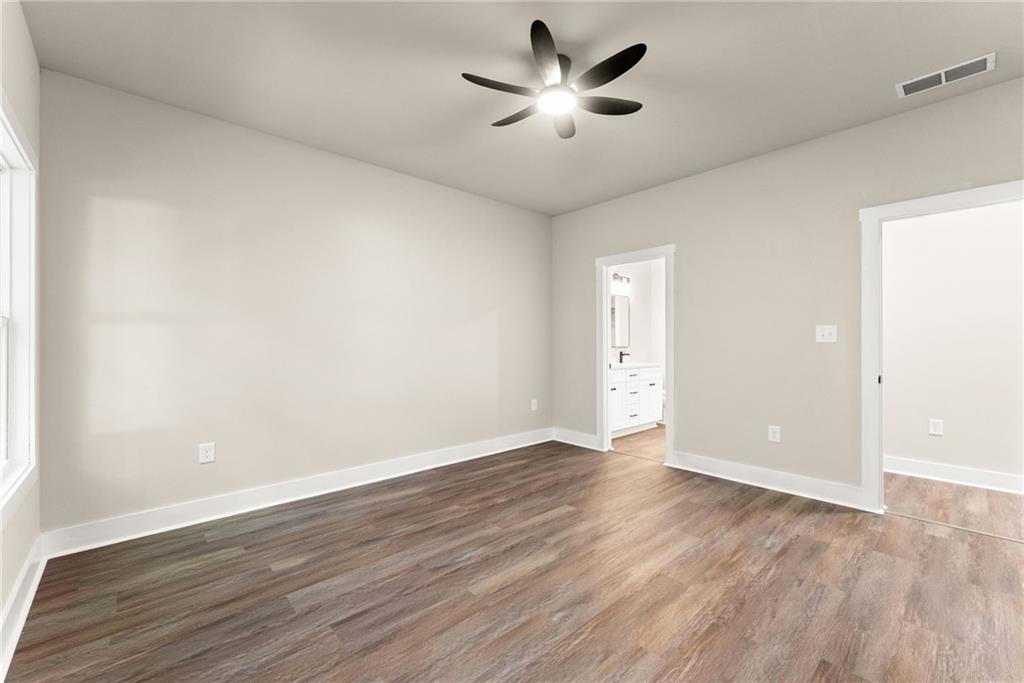 43 Anderson Street Jefferson, GA 30549 - Photo 18 of 45 an empty room with wooden floor and windows