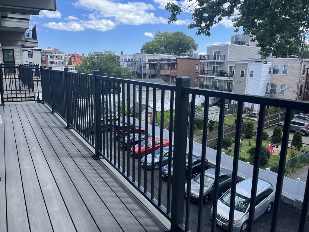 765 East 3rd Street, Unit 202 Boston, MA 02127 - Photo 6 of 9 a view of a balcony with wooden floor and city view