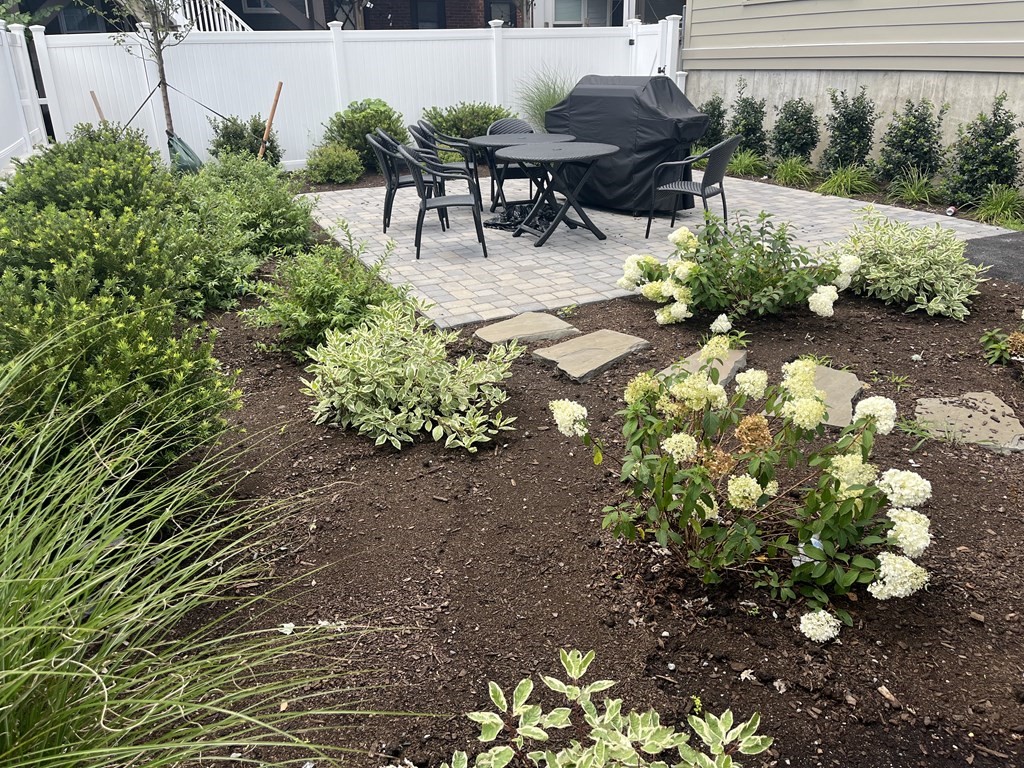 765 East 3rd Street, Unit 202 Boston, MA 02127 - Photo 7 of 9 a patio with table and chairs and potted plants