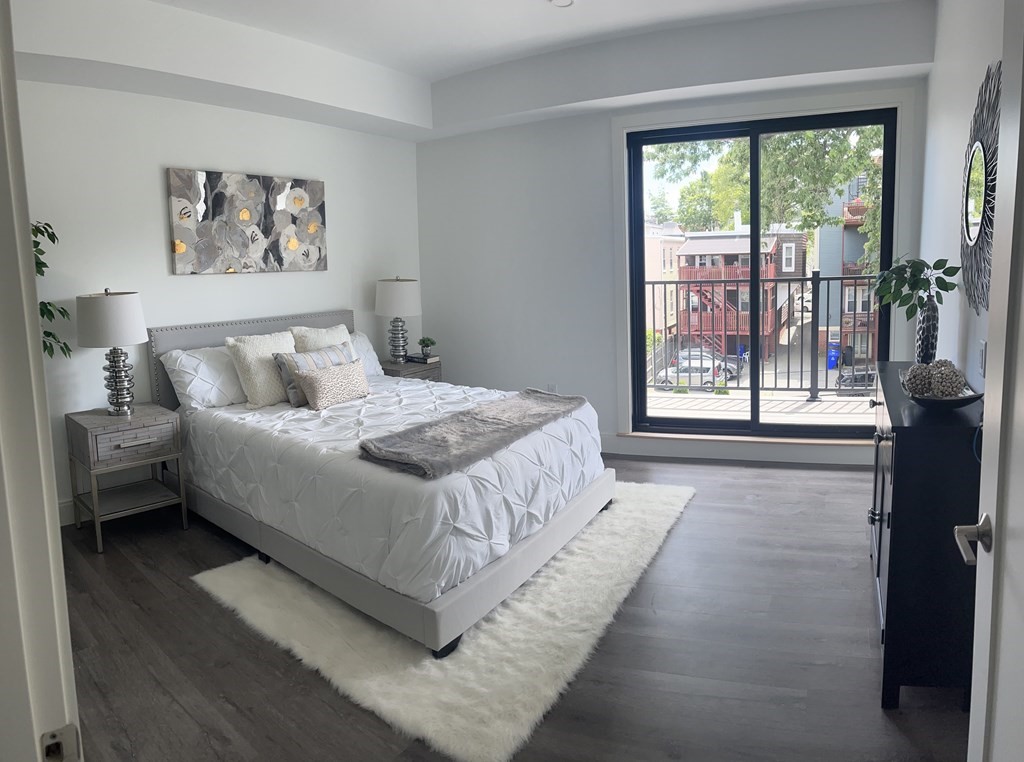 765 East 3rd Street, Unit 202 Boston, MA 02127 - Photo 9 of 9 a bedroom with a bed painting and a large window