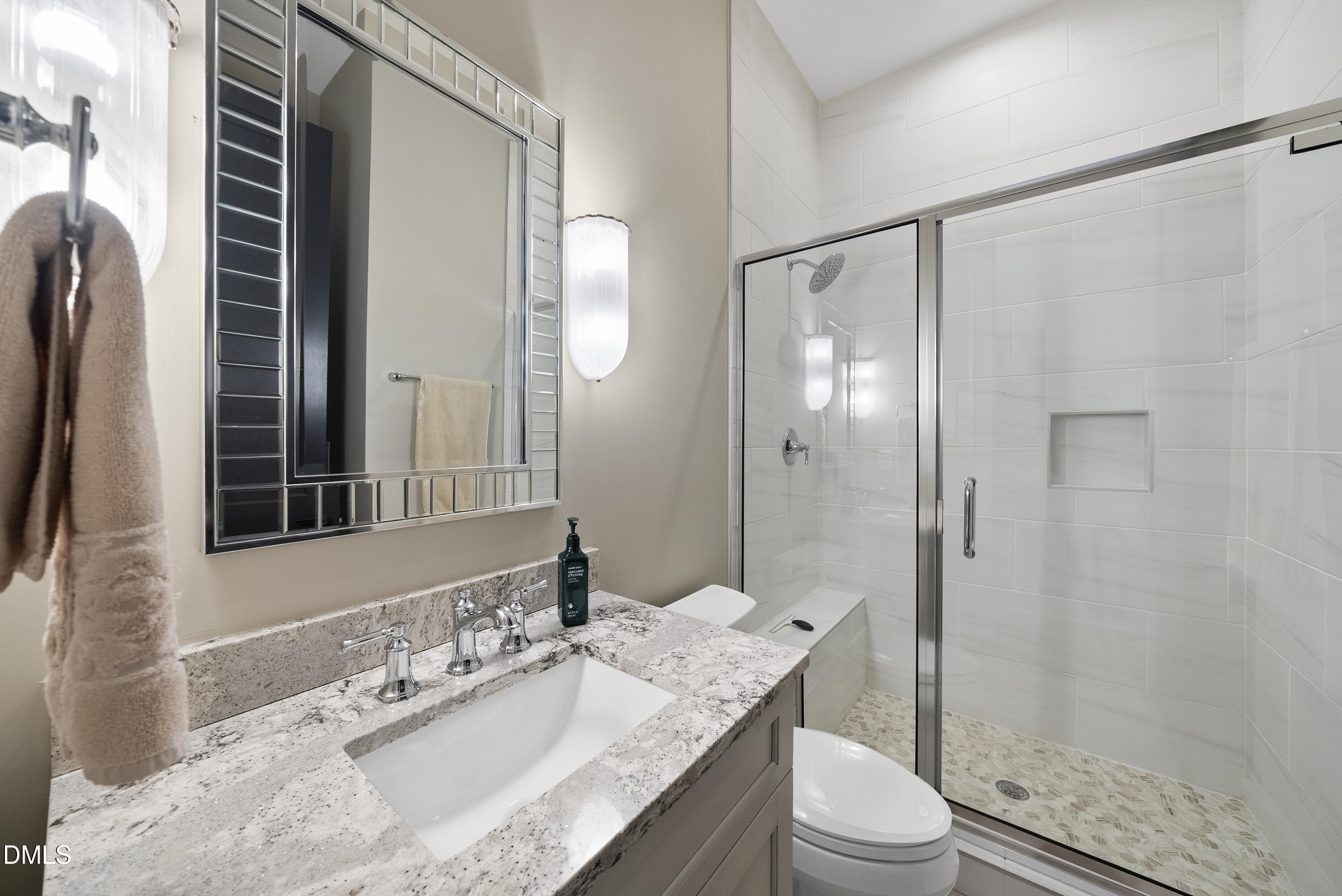 5109 Wainscott Way Raleigh, NC 27612 - Photo 23 of 52 a bathroom with a granite countertop sink toilet a mirror a vanity and shower