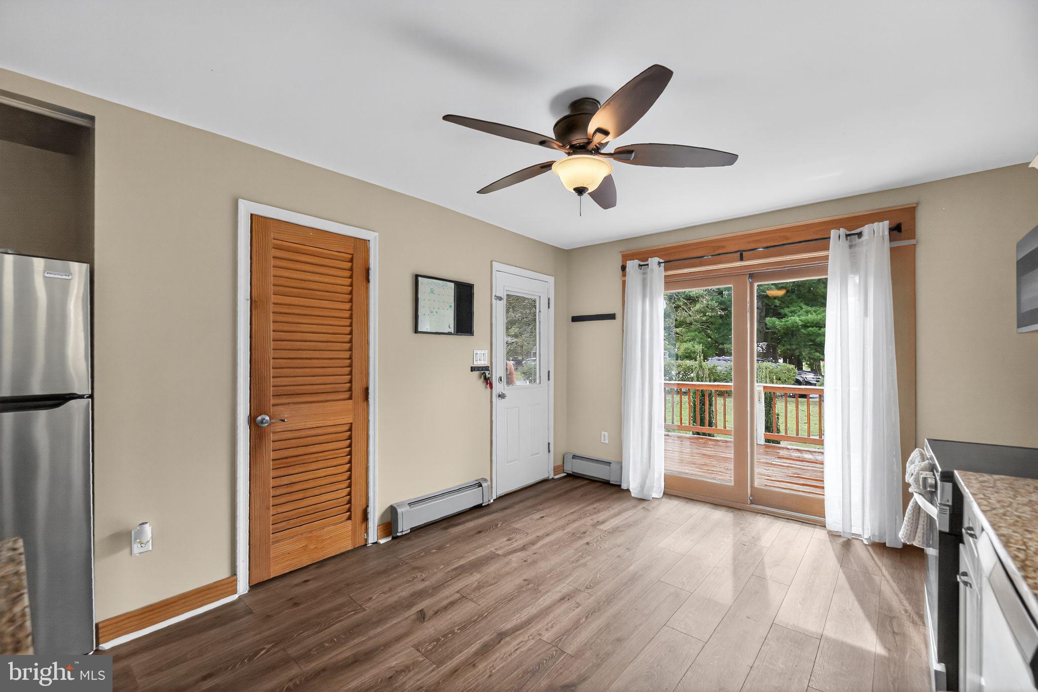 1115 Bridgeboro Road Beverly, NJ 08010 - Photo 14 of 39 a view of a livingroom with wooden floor and a ceiling fan