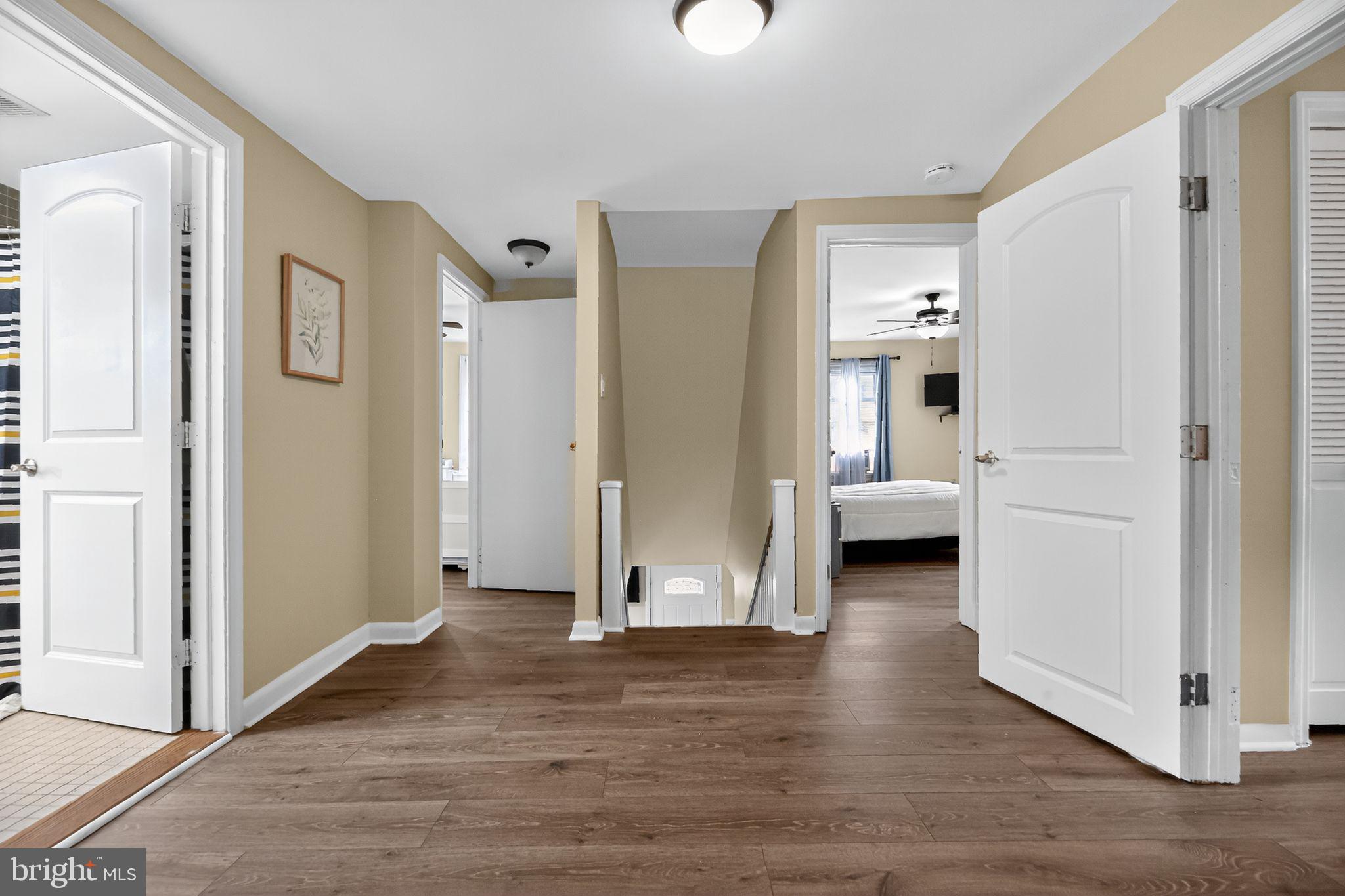 1115 Bridgeboro Road Beverly, NJ 08010 - Photo 18 of 39 a view of a hallway with wooden floor and a living room