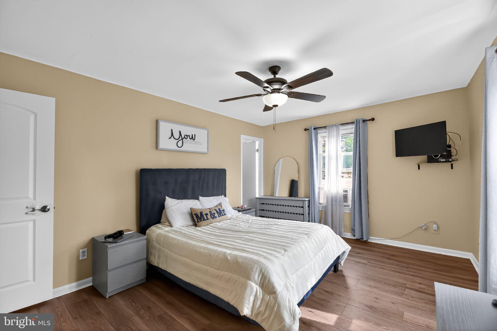 1115 Bridgeboro Road Beverly, NJ 08010 - Photo 23 of 39 a bedroom with a large bed a flat tv screen and closet