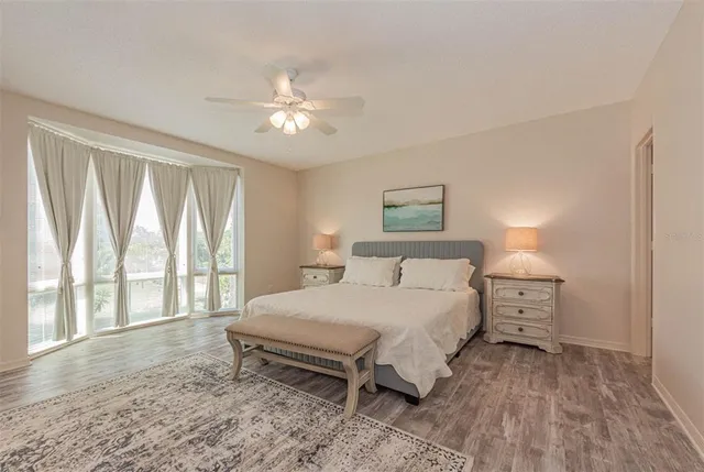 a bedroom with a large bed and a large window