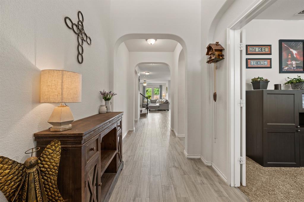 15817 White Mill Road Fort Worth, TX 76177 - Photo 5 of 27 a view of a hallway that has a couch and wooden floor